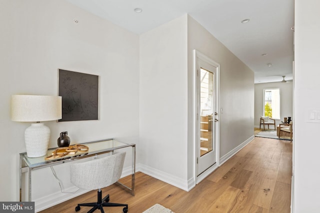 office space featuring light hardwood / wood-style flooring and ceiling fan