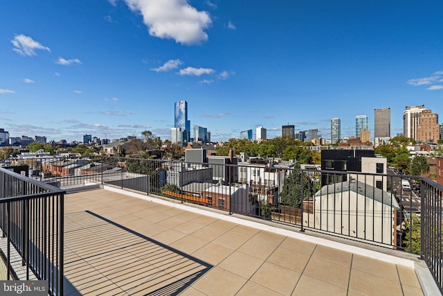 view of patio / terrace with a view of city and a balcony