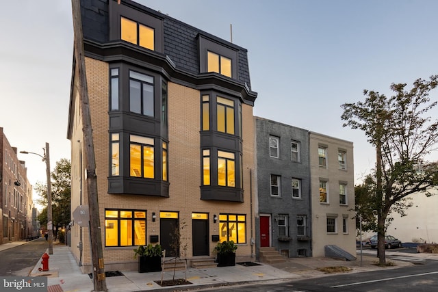 property at dusk featuring entry steps