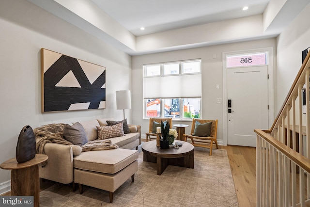 living room with stairs, light wood-style flooring, and recessed lighting