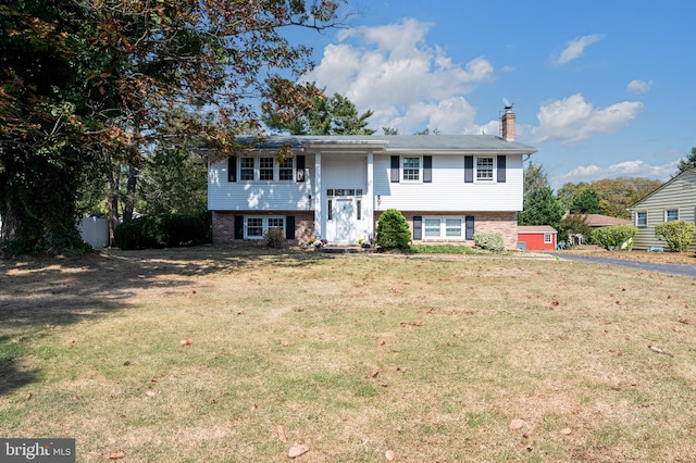 raised ranch featuring a front yard