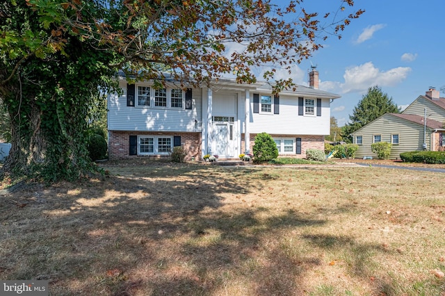 raised ranch with a front yard