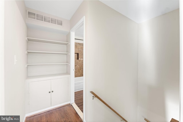 hallway with dark hardwood / wood-style flooring