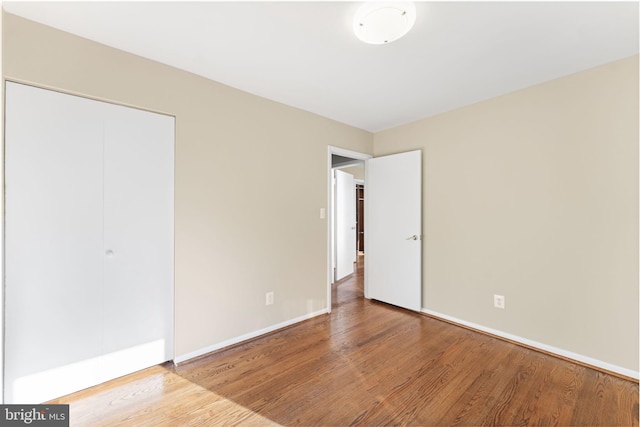 unfurnished bedroom with a closet and light hardwood / wood-style flooring