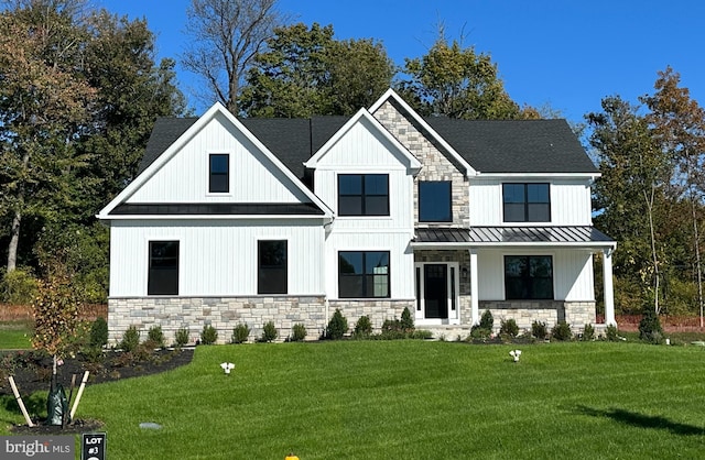 modern farmhouse featuring a front yard and covered porch