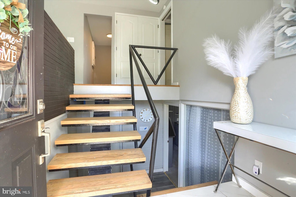 stairs featuring wood-type flooring