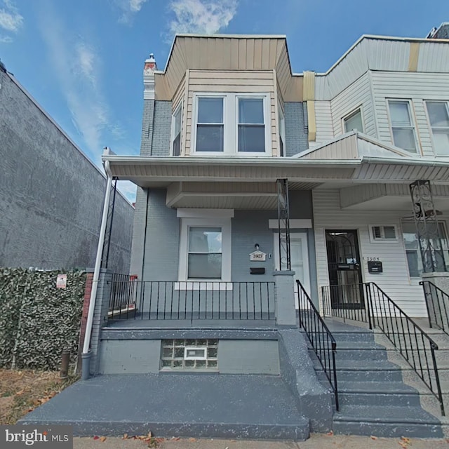 townhome / multi-family property with covered porch