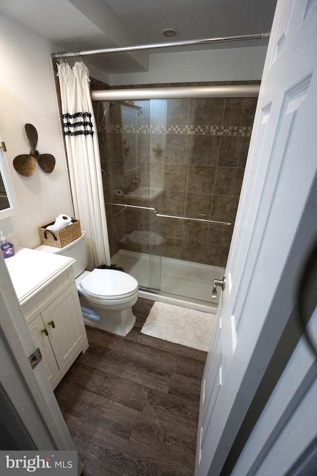 bathroom with vanity, wood-type flooring, a shower with curtain, and toilet