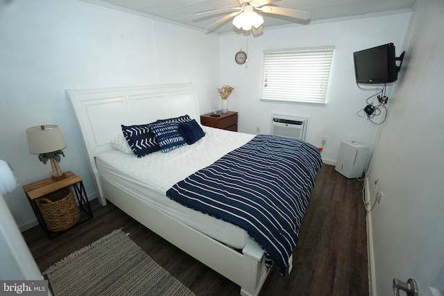 bedroom with ceiling fan, an AC wall unit, ornamental molding, and dark hardwood / wood-style floors