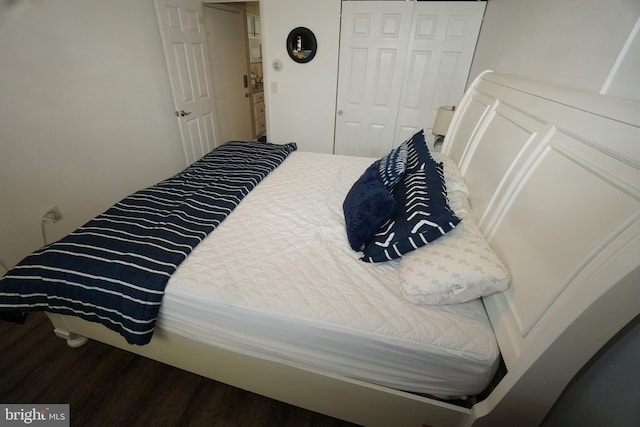 bedroom featuring wood-type flooring and a closet