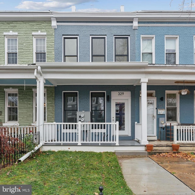 townhome / multi-family property featuring a porch