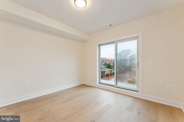 spare room with light hardwood / wood-style floors