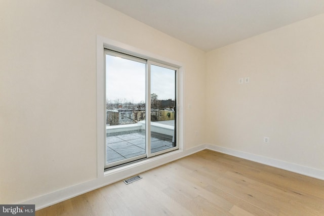 spare room featuring light wood-type flooring