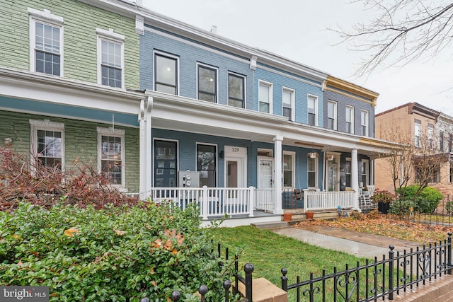 townhome / multi-family property featuring a porch