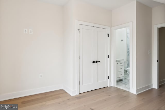 corridor with light wood-type flooring