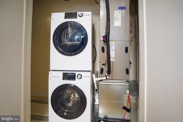 laundry area featuring stacked washer / drying machine