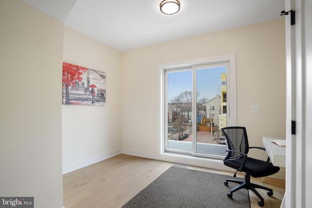 office space with light hardwood / wood-style flooring