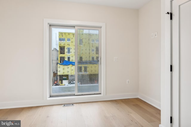 spare room with light hardwood / wood-style flooring