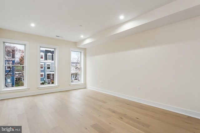 unfurnished room with light hardwood / wood-style flooring