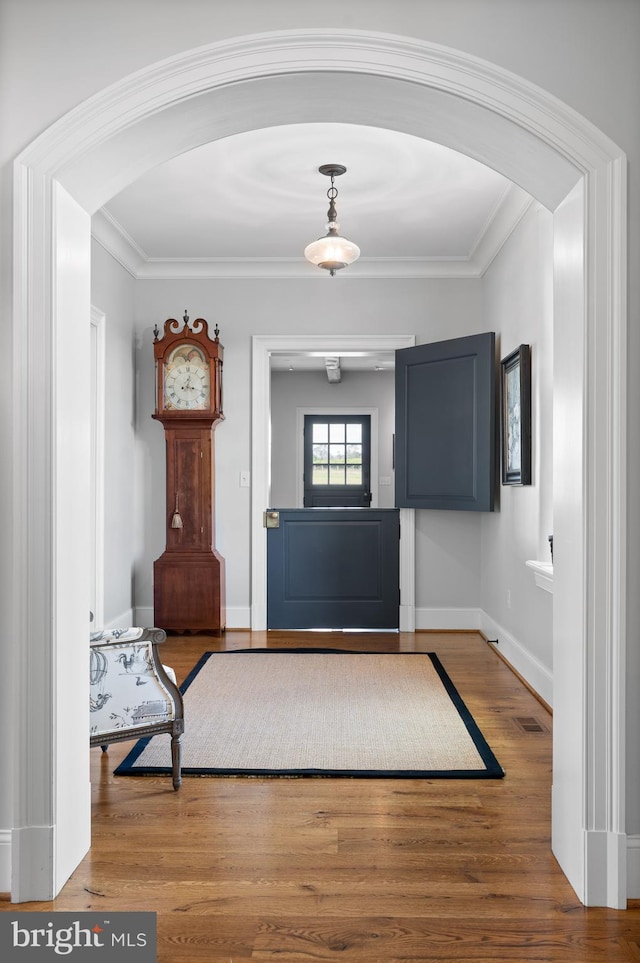 1484 W Strasburg Rd, West Chester, PA 19382 - entrance foyer with arched walkways, visible vents, wood finished floors, and crown molding
