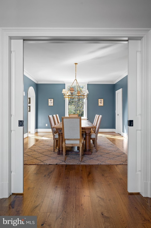 1484 W Strasburg Rd, West Chester, PA 19382 - dining area with an inviting chandelier, ornamental molding, baseboards, arched walkways, and hardwood / wood-style flooring