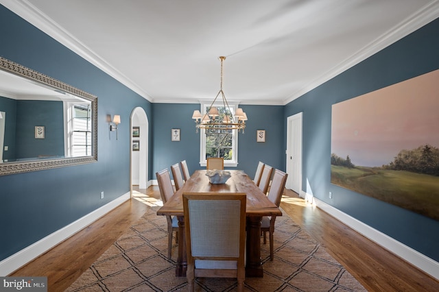 1484 W Strasburg Rd, West Chester, PA 19382 - dining space with an inviting chandelier, wood finished floors, arched walkways, and a wealth of natural light