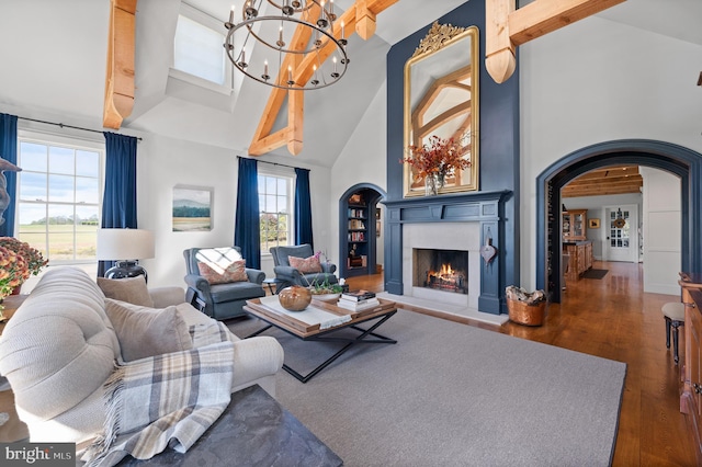 1484 W Strasburg Rd, West Chester, PA 19382 - living area featuring high vaulted ceiling, a warm lit fireplace, wood finished floors, arched walkways, and an inviting chandelier