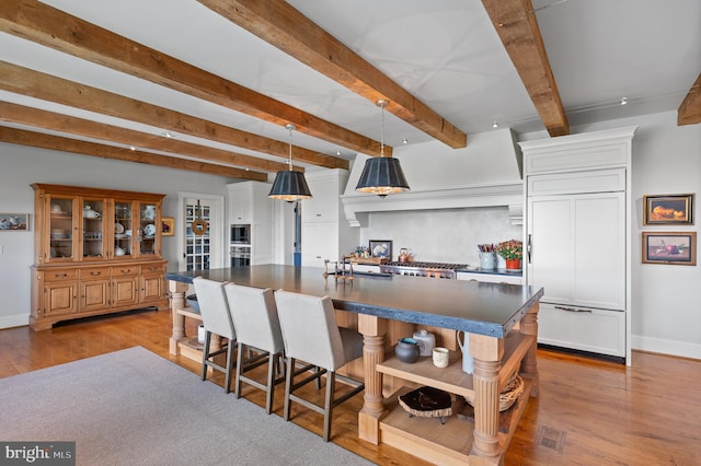 1484 W Strasburg Rd, West Chester, PA 19382 - kitchen with wood finished floors, dark countertops, paneled built in refrigerator, open shelves, and a large island with sink