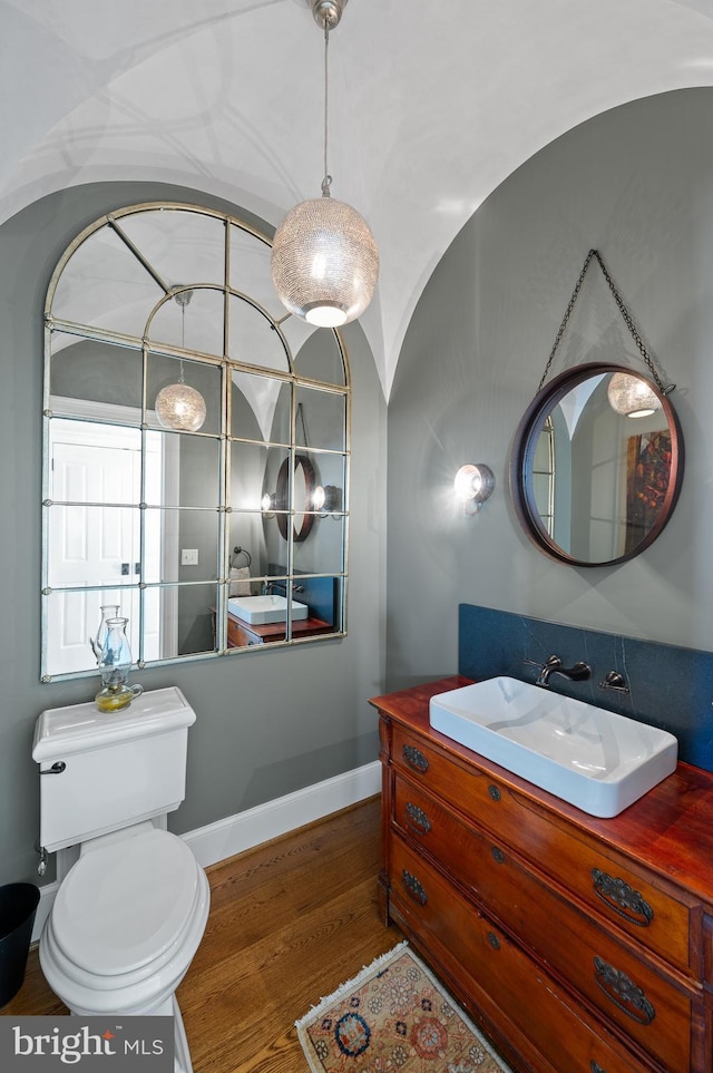 1484 W Strasburg Rd, West Chester, PA 19382 - bathroom featuring vanity, lofted ceiling, toilet, baseboards, and wood finished floors