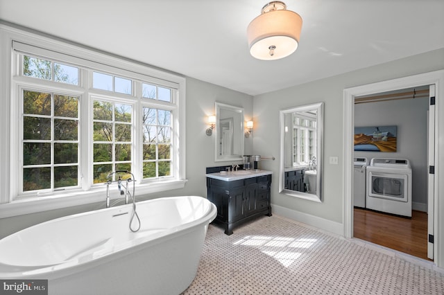 1484 W Strasburg Rd, West Chester, PA 19382 - full bath with vanity, a freestanding tub, baseboards, and washer and dryer