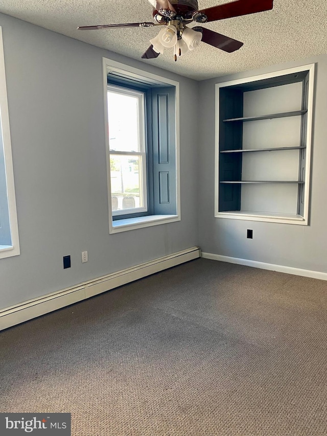 carpeted spare room featuring ceiling fan, baseboard heating, and a textured ceiling