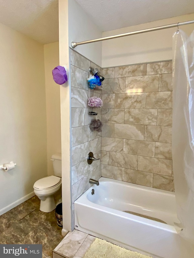 bathroom with a textured ceiling, shower / tub combo, toilet, and tile patterned flooring