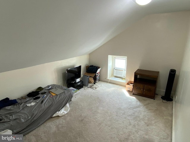 additional living space featuring cooling unit, vaulted ceiling, and light colored carpet