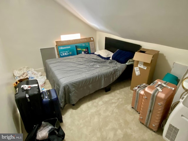 bedroom featuring lofted ceiling and light colored carpet