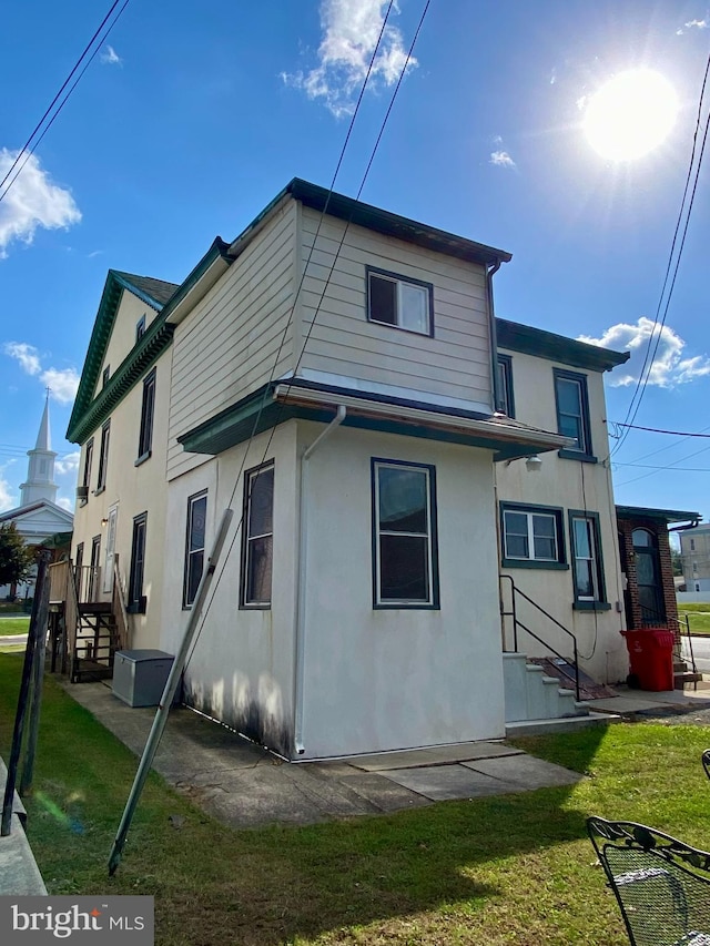 rear view of property with a yard