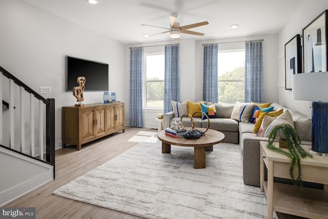 living room with ceiling fan, light hardwood / wood-style flooring, and plenty of natural light