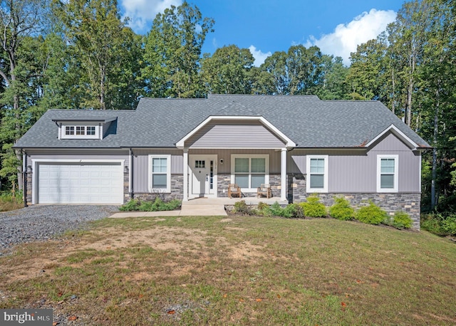 craftsman-style home with a front yard, covered porch, and a garage