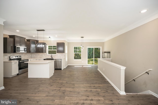 kitchen featuring hanging light fixtures, dark brown cabinetry, stainless steel appliances, and a kitchen island