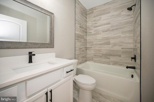 full bathroom with toilet, tiled shower / bath combo, and vanity