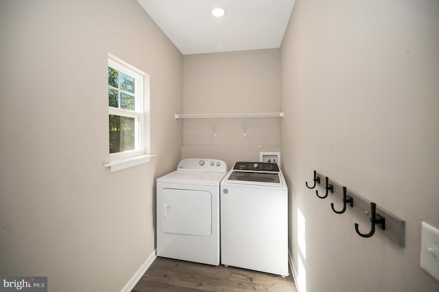 laundry area with dark hardwood / wood-style flooring and washer and dryer