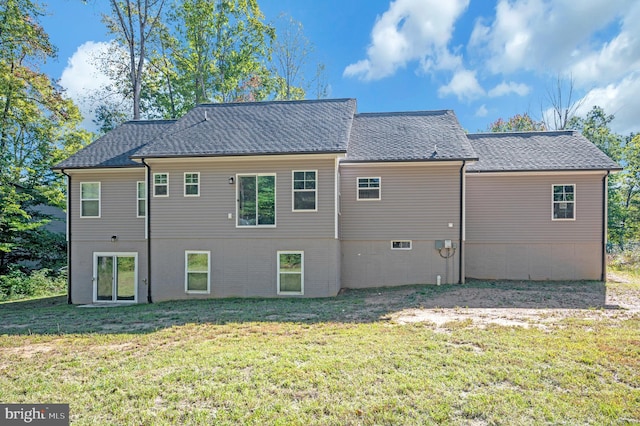 back of property featuring a lawn