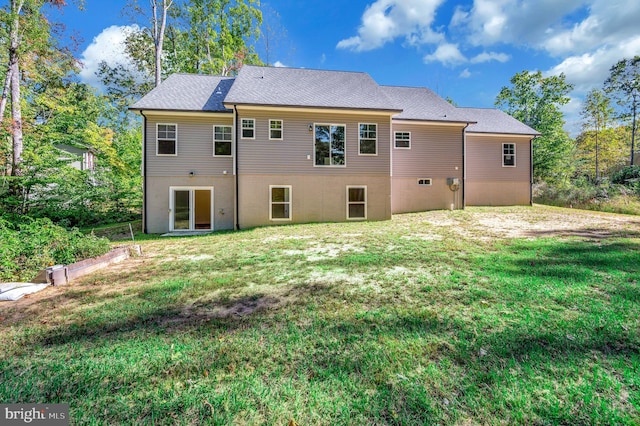 back of property featuring a lawn