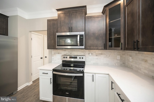 kitchen featuring stainless steel appliances, backsplash, dark hardwood / wood-style flooring, dark brown cabinets, and white cabinets