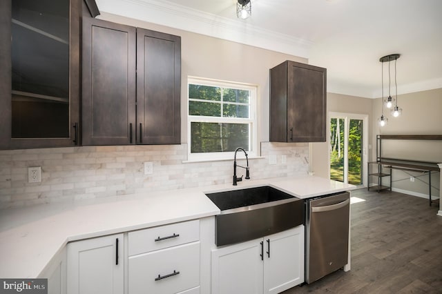 kitchen featuring tasteful backsplash, stainless steel dishwasher, sink, hanging light fixtures, and white cabinets