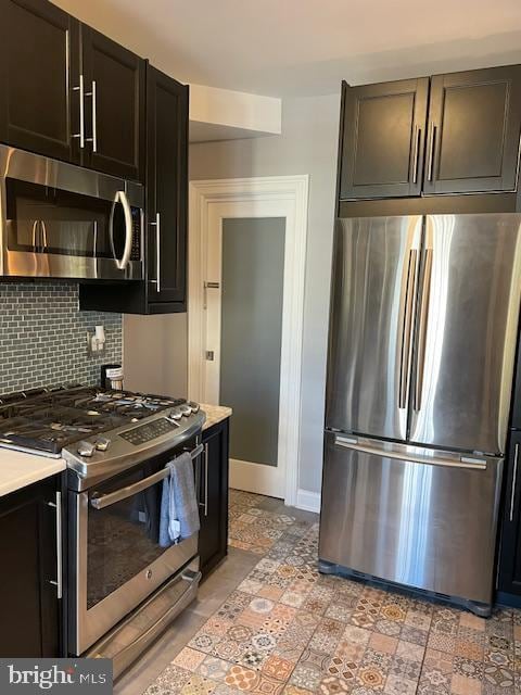 kitchen with stainless steel appliances and backsplash