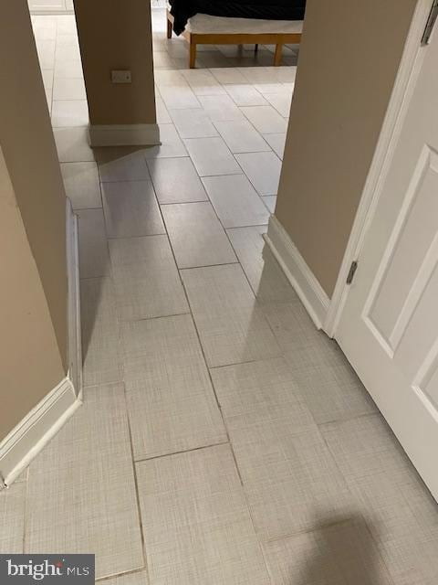 corridor featuring light tile patterned flooring