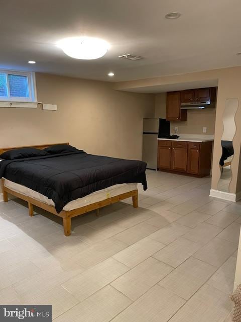 bedroom featuring white refrigerator