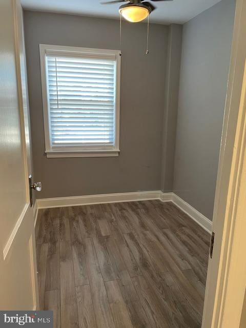 spare room featuring ceiling fan and dark hardwood / wood-style flooring