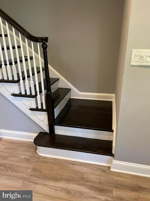 staircase with hardwood / wood-style flooring