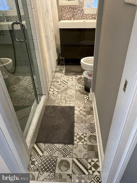 bathroom with vanity, toilet, an enclosed shower, and tile patterned floors